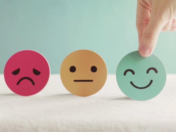 Three faces showing different emotions - sad, neutral and happy